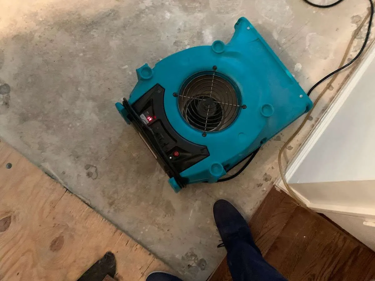 Air mover drying subfloor during Leak Detection & Repair in Eden Prairie